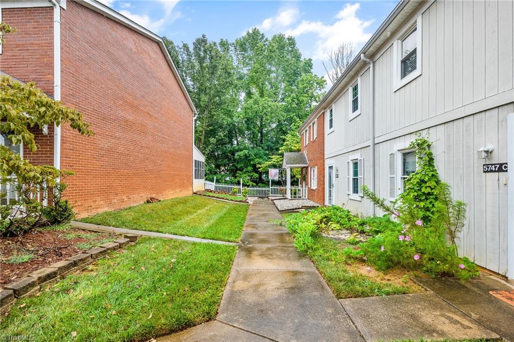 5747 Bramblegate Road, Unit A Greensboro, NC 27409 - Photo 19 of 19 Front sidewalk from opposite end of unit