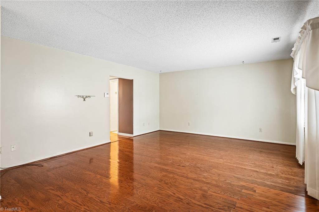 5747 Bramblegate Road, Unit A Greensboro, NC 27409 - Photo 3 of 19 Living room from front door