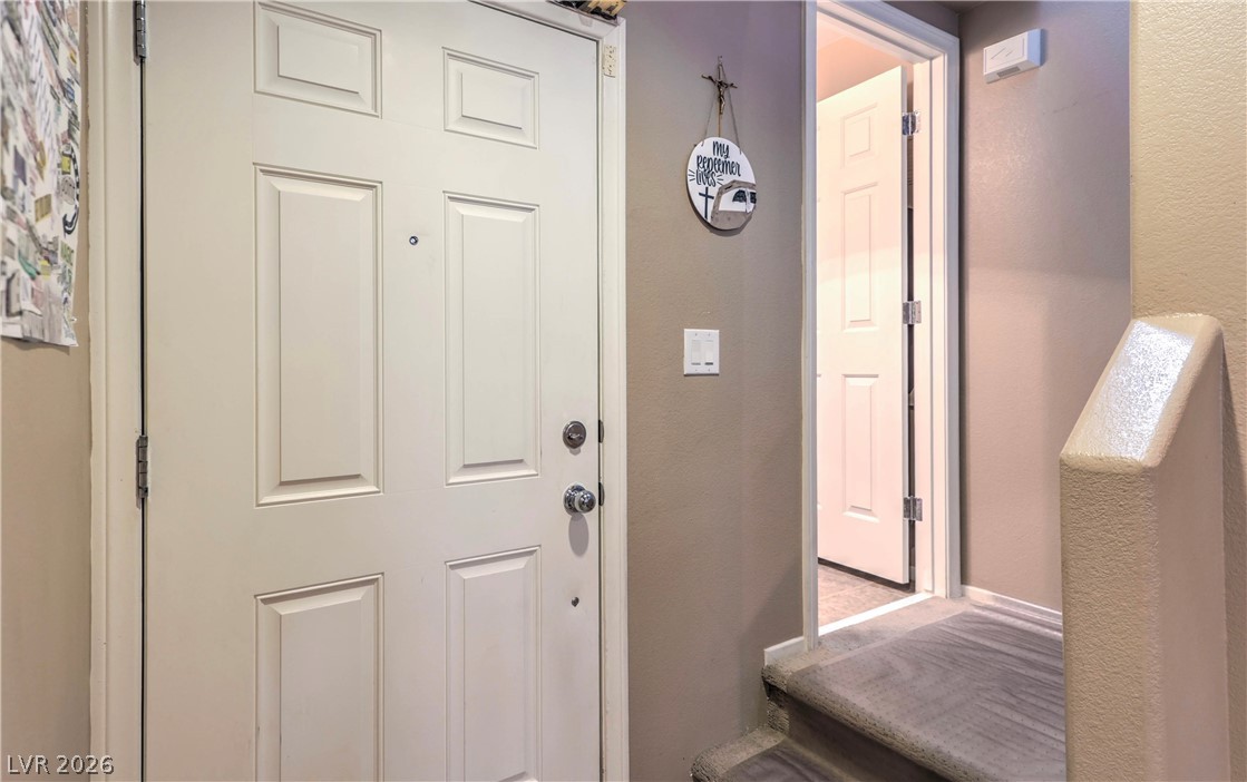 9068 West Alluring Avenue Las Vegas, NV 89149 - Photo 10 of 23 The bright entry features classic paneled doors and leads to a welcoming staircase.