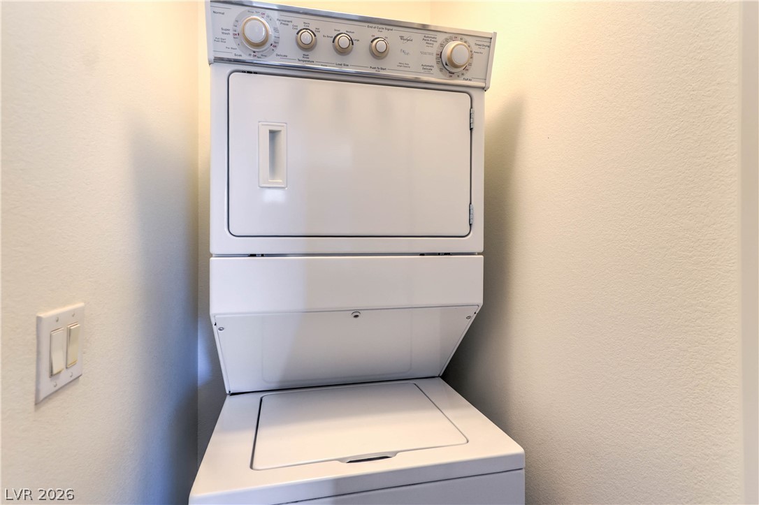9068 West Alluring Avenue Las Vegas, NV 89149 - Photo 13 of 23 This dedicated laundry space features a convenient stacked washer and dryer for effortless living.