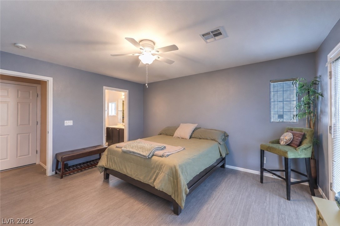 9068 West Alluring Avenue Las Vegas, NV 89149 - Photo 14 of 23 This serene bedroom offers a private retreat with modern flooring and a calming atmosphere.