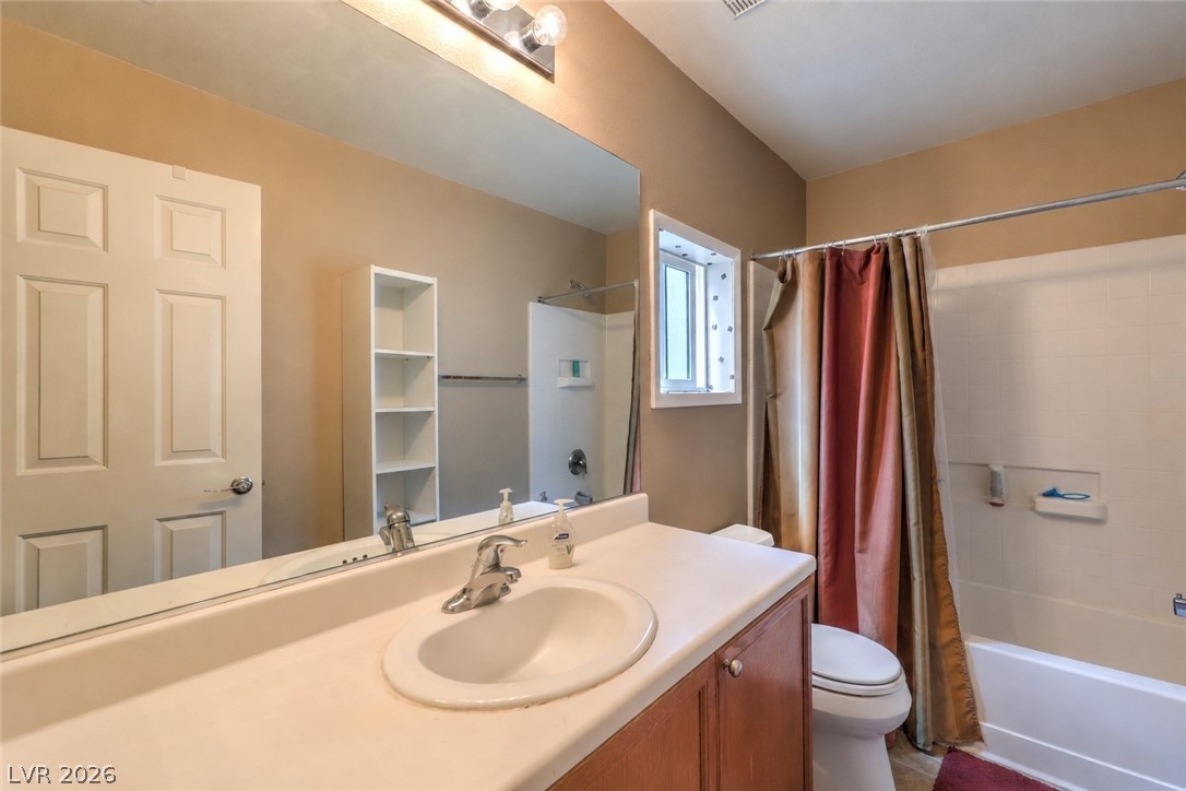 9068 West Alluring Avenue Las Vegas, NV 89149 - Photo 17 of 23 This functional bathroom features a single vanity, ample mirror space, and a combination shower and tub.