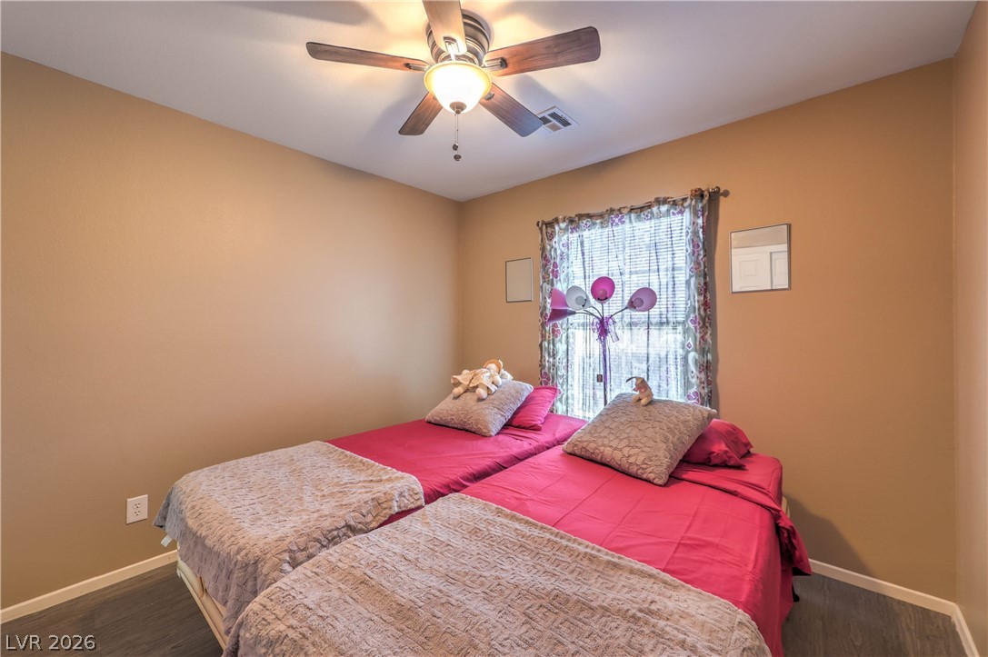 9068 West Alluring Avenue Las Vegas, NV 89149 - Photo 18 of 23 This cozy bedroom features durable flooring and ample natural light, ideal for peaceful living.