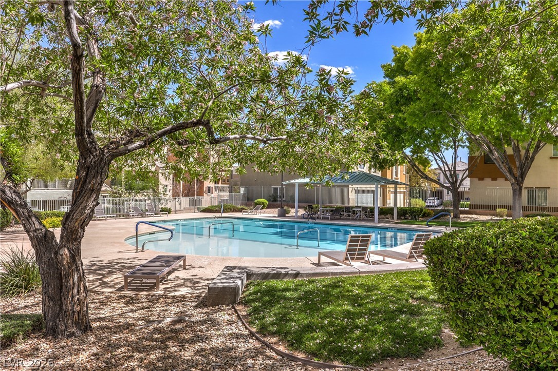9068 West Alluring Avenue Las Vegas, NV 89149 - Photo 19 of 23 This tranquil outdoor pool area offers a refreshing oasis for relaxation and recreation.