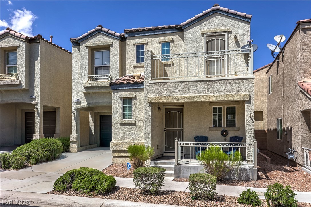9068 West Alluring Avenue Las Vegas, NV 89149 - Photo 2 of 23 This desert dwelling features a charming front porch, a balcony, and easy access to a covered parking area.