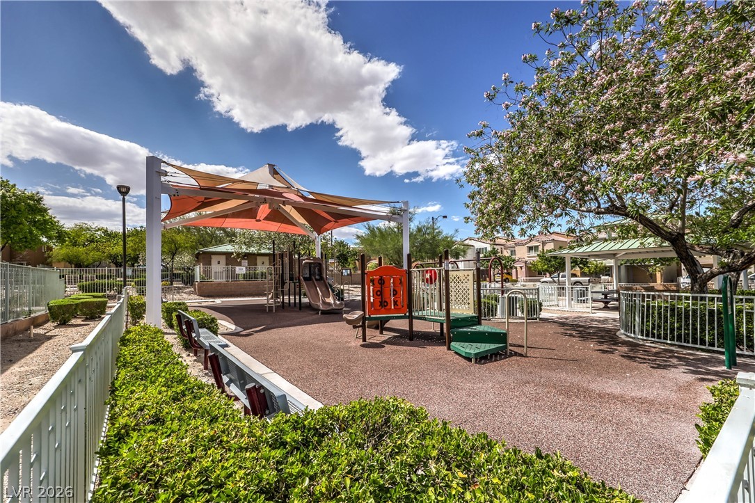 9068 West Alluring Avenue Las Vegas, NV 89149 - Photo 21 of 23 This vibrant playground offers diverse play structures under a protective shade canopy.