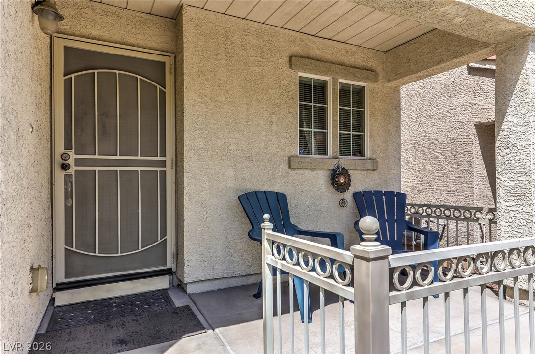 9068 West Alluring Avenue Las Vegas, NV 89149 - Photo 3 of 23 Welcome to a charming front porch, complete with a security screen door and protective railing.