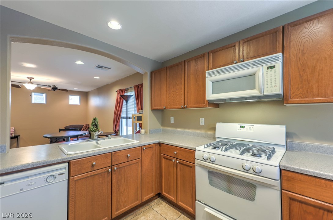 9068 West Alluring Avenue Las Vegas, NV 89149 - Photo 6 of 23 This kitchen provides practical design with ample cabinetry and essential appliances for everyday living.