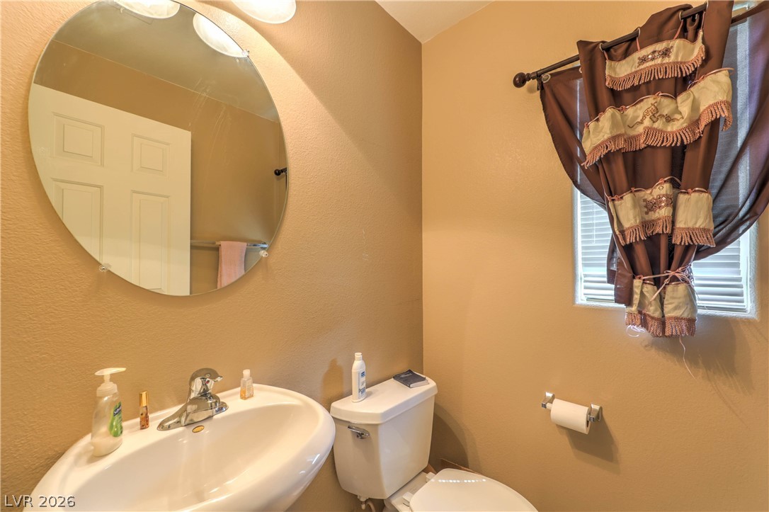 9068 West Alluring Avenue Las Vegas, NV 89149 - Photo 9 of 23 This clean and inviting bathroom features a modern pedestal sink and a bright window.