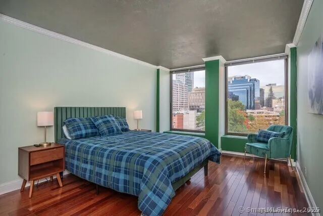 a bedroom with a bed and wooden floor
