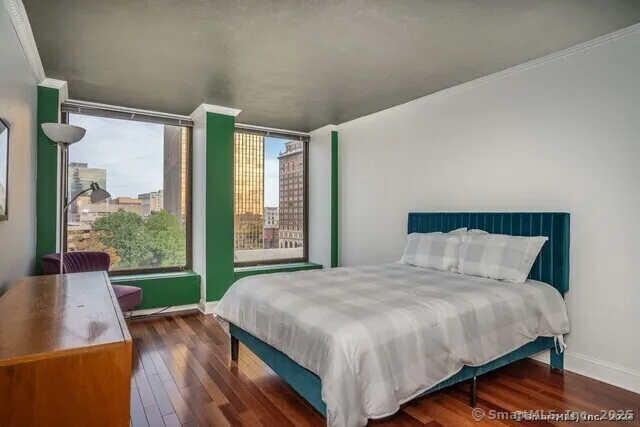 a bed sitting in a bedroom next to a window