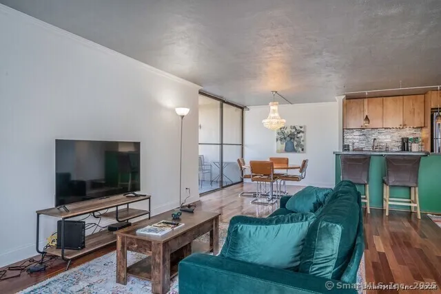 a living room with furniture and a flat screen tv