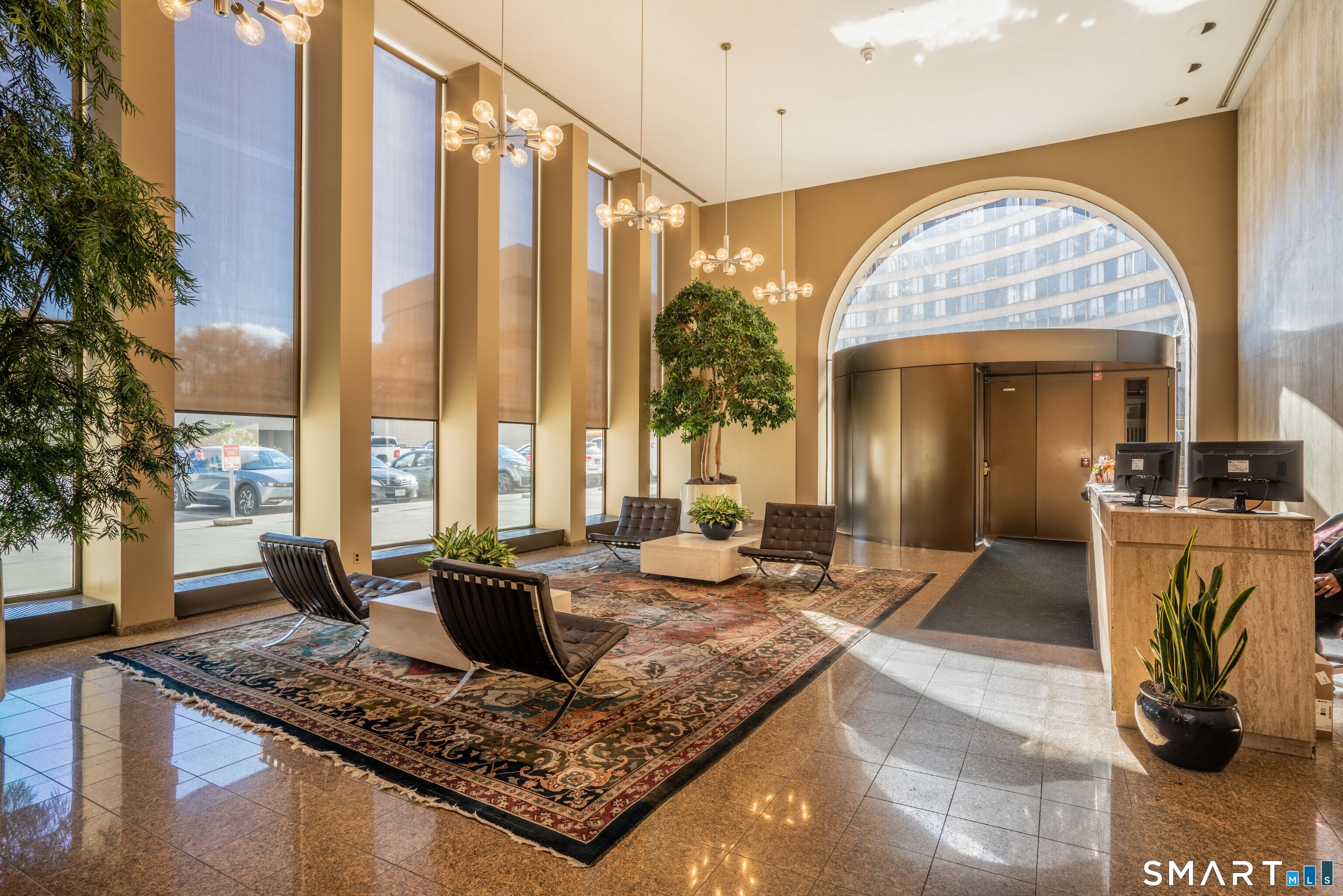 1 Gold Street, Unit 11E Hartford, CT 06103 - Photo 3 of 25 a view of a kitchen with granite countertop a couch and a large window