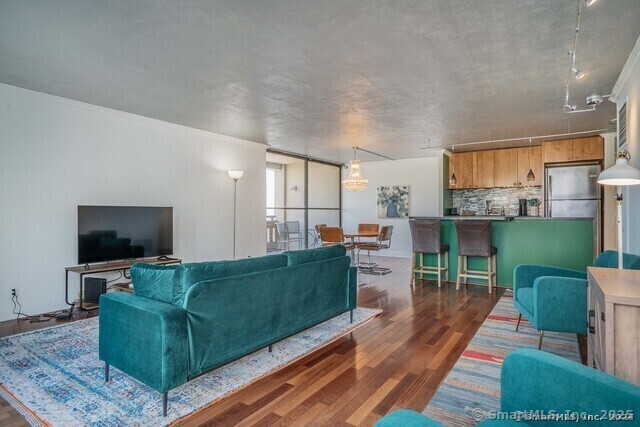 1 Gold Street, Unit 11E Hartford, CT 06103 - Photo 6 of 25 a living room with furniture and a flat screen tv