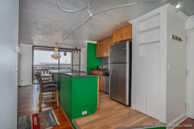a kitchen with a refrigerator and a table