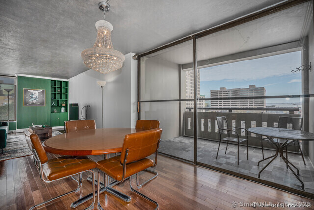 1 Gold Street, Unit 11E Hartford, CT 06103 - Photo 10 of 25 a view of a dining room with furniture wooden floor and chandelier