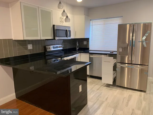 a kitchen with a refrigerator stove and microwave