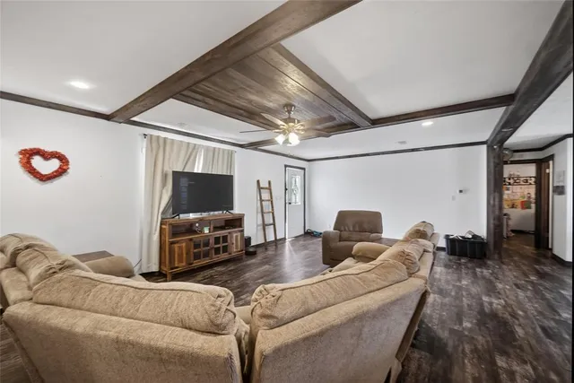 a kitchen with stainless steel appliances granite countertop a dining table chairs stove refrigerator and cabinets