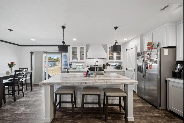 a kitchen with sink cabinets and wooden floor