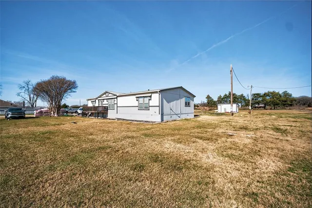 a house view with swimming pool and trees in the background