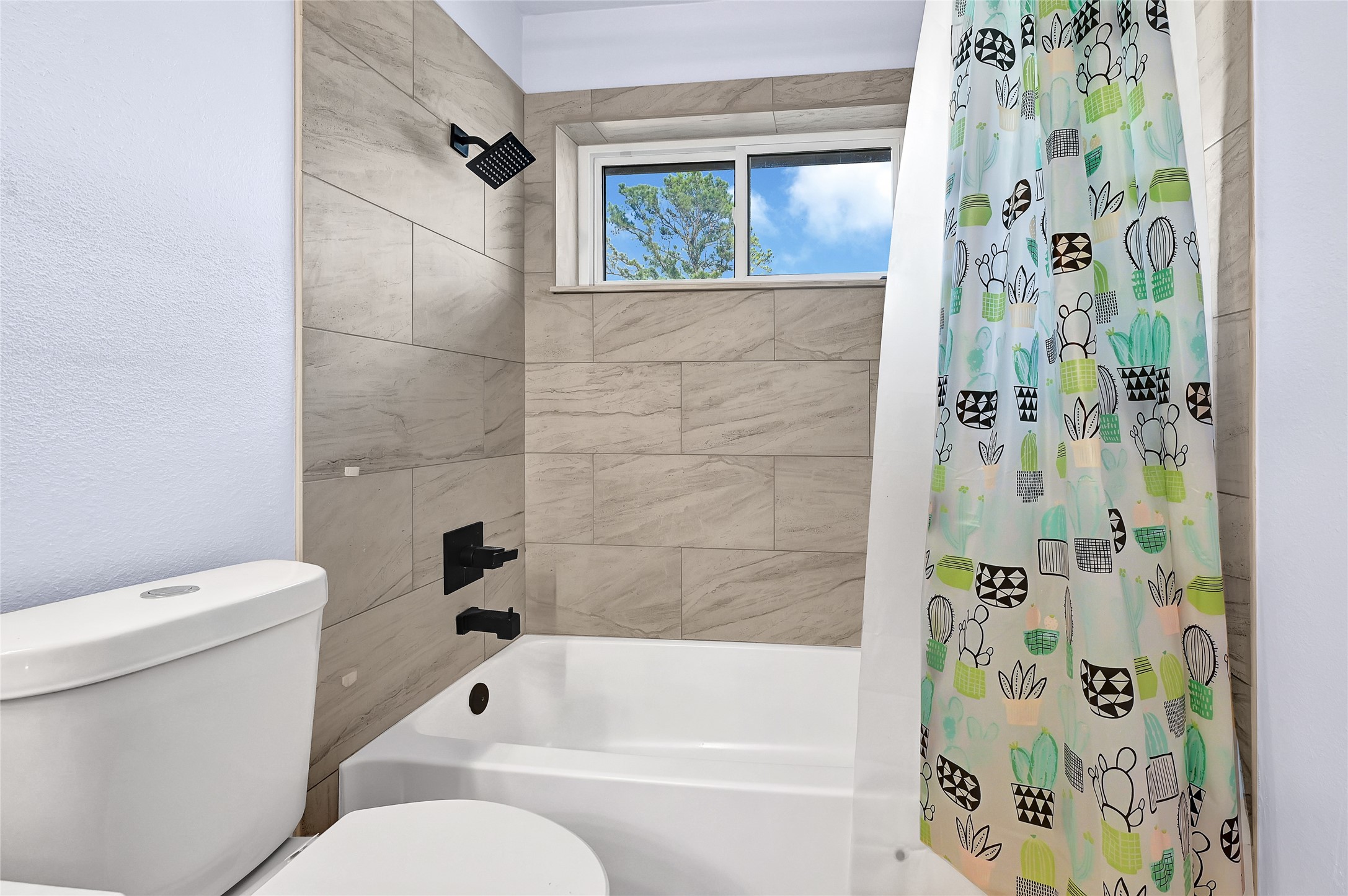 5910 Rolff Lane Houston, TX 77084 - Photo 21 of 50 Full bath with updated tilework, clean finishes, and functional layout.