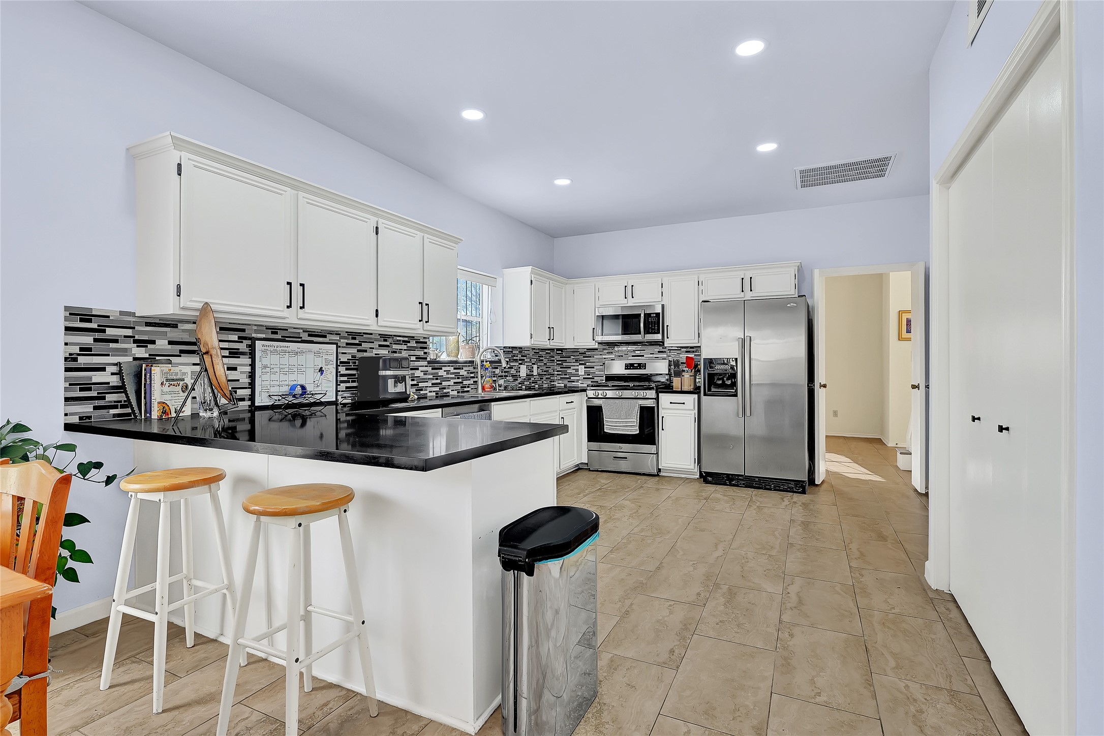 5910 Rolff Lane Houston, TX 77084 - Photo 24 of 50 Kitchen with breakfast bar seating and seamless connection to living areas.