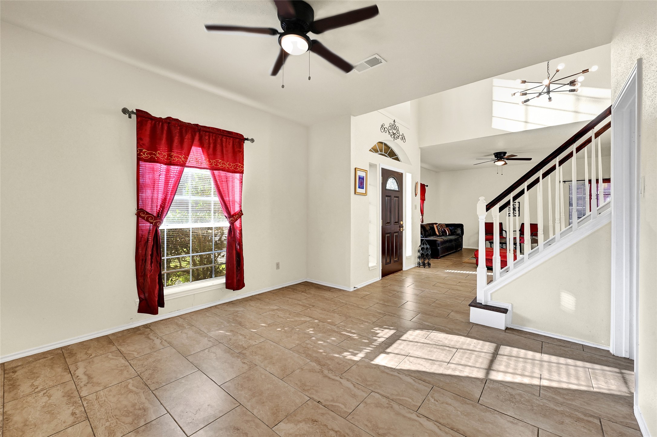 5910 Rolff Lane Houston, TX 77084 - Photo 32 of 50 Living area with ceiling fan and easy connection to the entry and main spaces.
