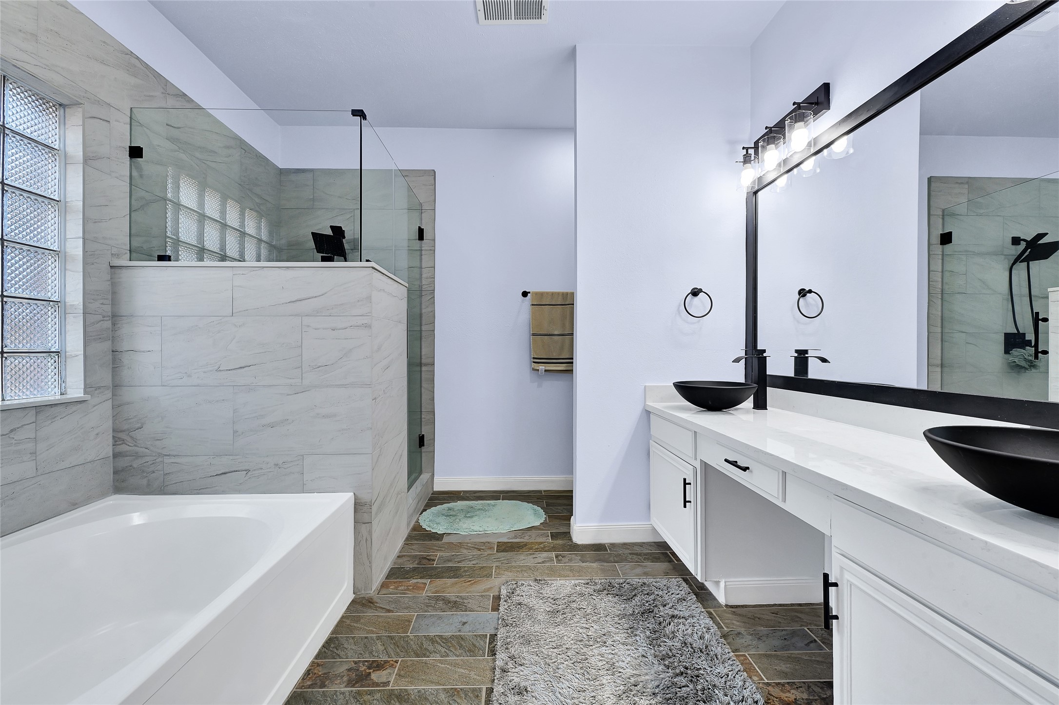 5910 Rolff Lane Houston, TX 77084 - Photo 41 of 50 Primary bathroom with soaking tub, separate shower, and dual vanity setup.