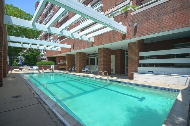 a view of a house with large trees