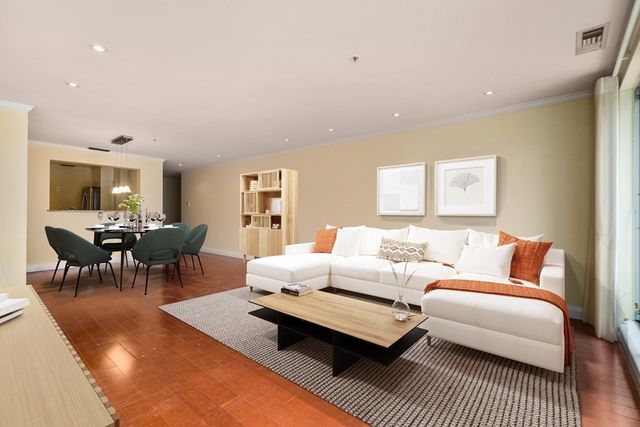 a living room with furniture a rug and a table