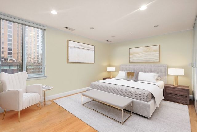 a spacious bedroom with a bed and a couch