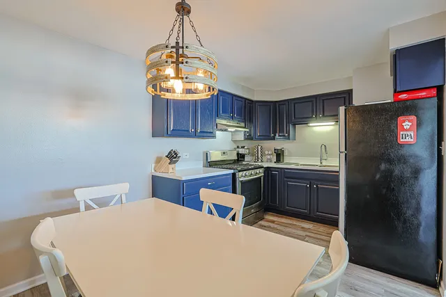 a kitchen with stainless steel appliances granite countertop a sink refrigerator and cabinets