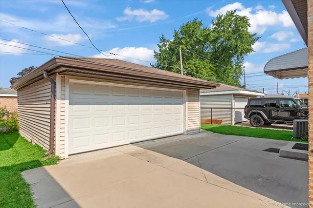 a side view of a house with a yard and garage
