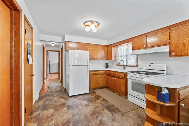 a kitchen with a refrigerator and a sink