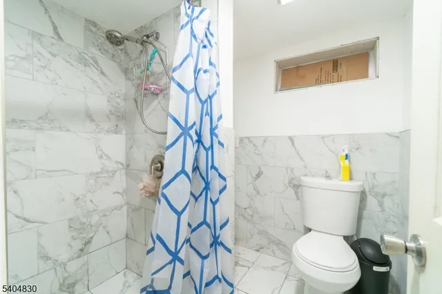 a white toilet sitting next to a bathroom sink