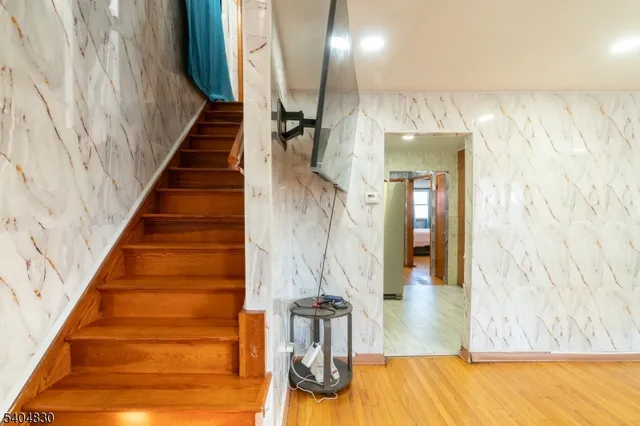 a view of entryway and hall with wooden floor