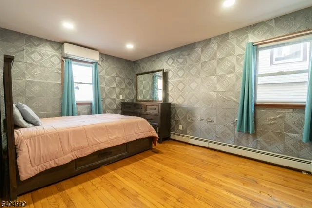 a spacious bedroom with a bed and a window