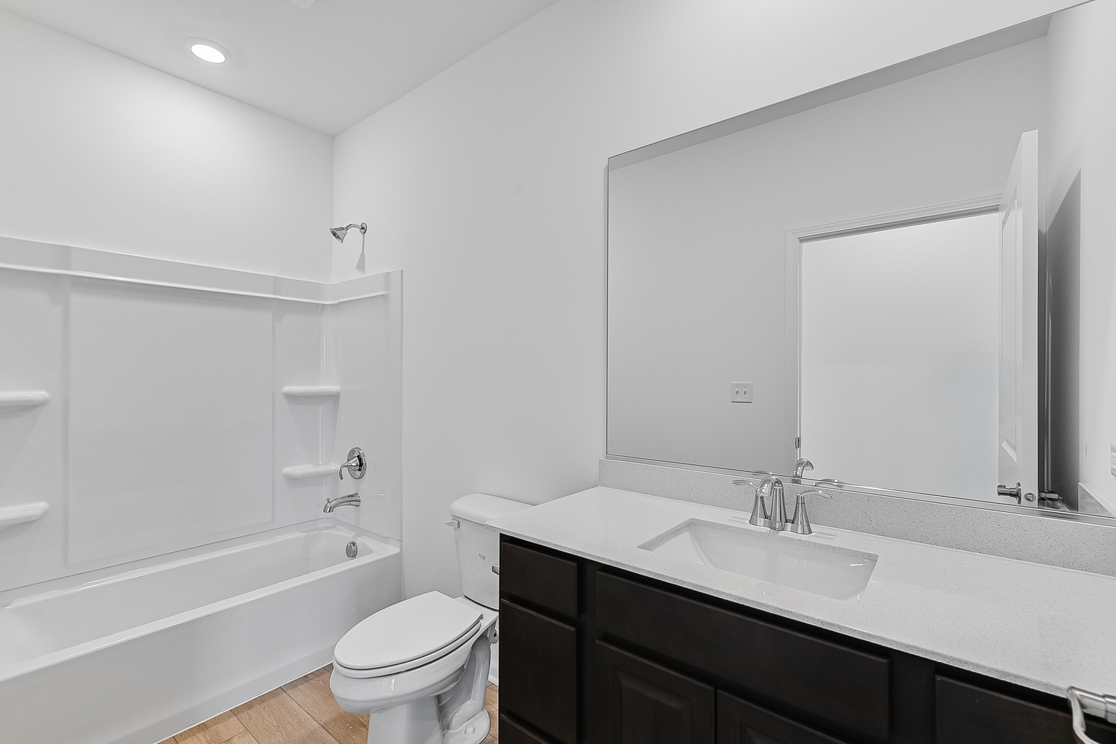 14905 South Mccarthy Circle Plainfield, IL 60544 - Photo 12 of 13 a bathroom with a granite countertop sink toilet a large mirror a bathtub and shower