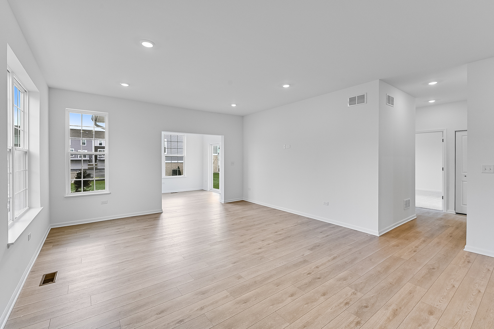 14905 South Mccarthy Circle Plainfield, IL 60544 - Photo 4 of 13 a view of an empty room with a window and wooden floor