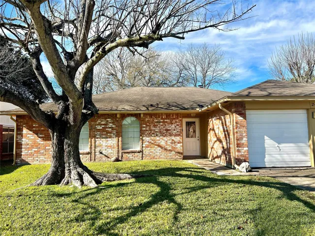 a view of a house with a backyard