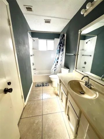 a bathroom with a sink mirror vanity and toilet