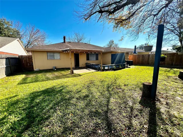 a view of a patio with table and chairs under an umbrella