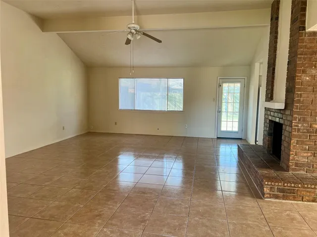 a view of a livingroom with furniture and chandelier fan