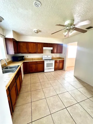 a kitchen with stainless steel appliances a stove a sink dishwasher and cabinets