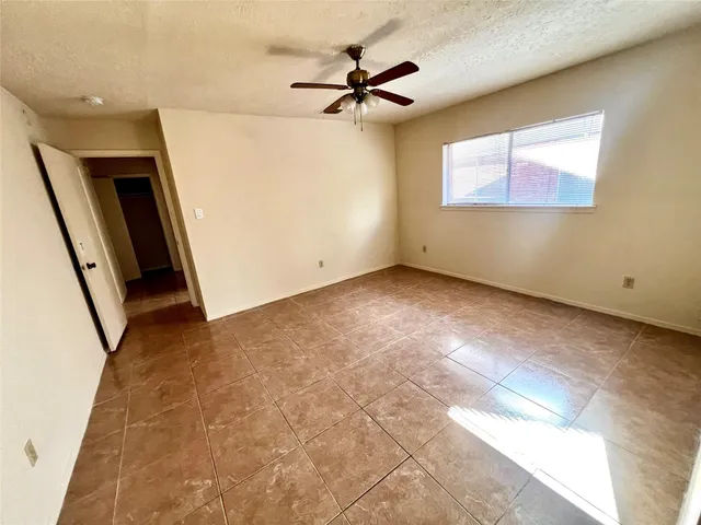 a view of a livingroom with a ceiling fan and window
