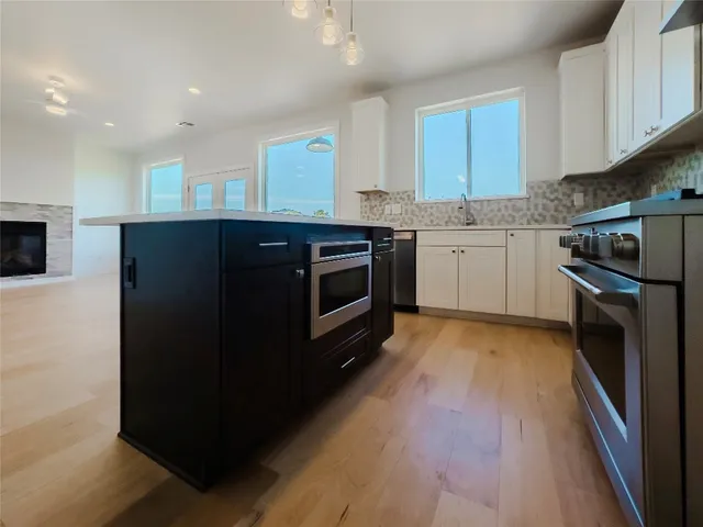 a kitchen with granite countertop a refrigerator and a stove