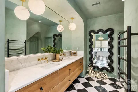 a bathroom with a double vanity sink mirror and shower