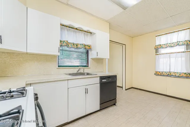a kitchen with a sink cabinets and wooden floor