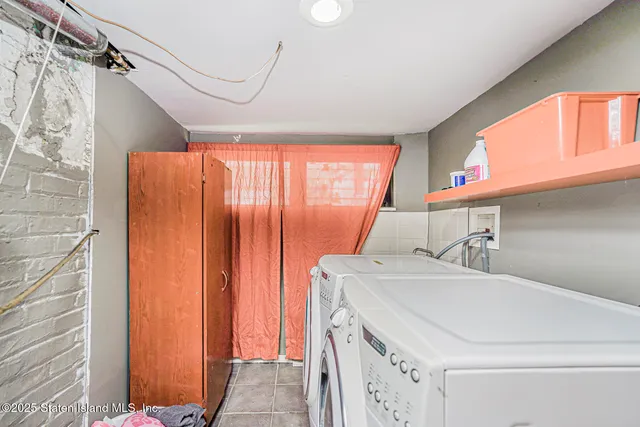 a view of a patio with table and chairs with wooden fence