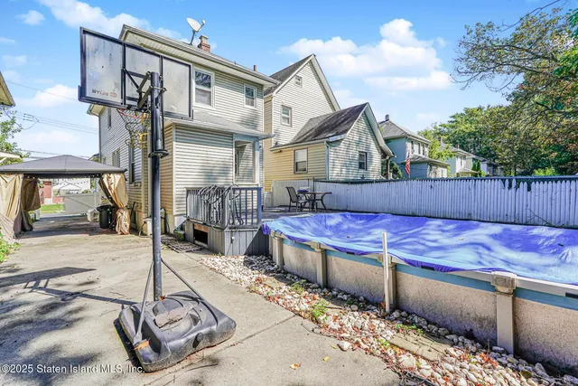 a view of a chair and table in the backyard